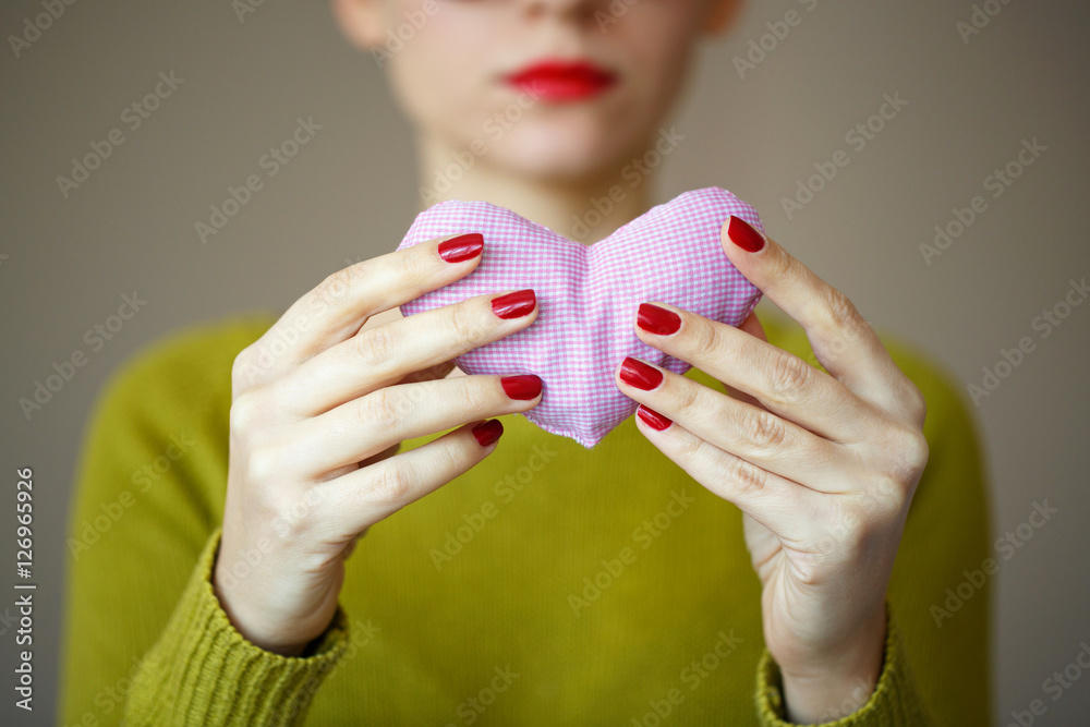 Close up on pink heart in hand of woman. Image of Valentines day Close up on pink heart in hand of woman. Image of Valentines day