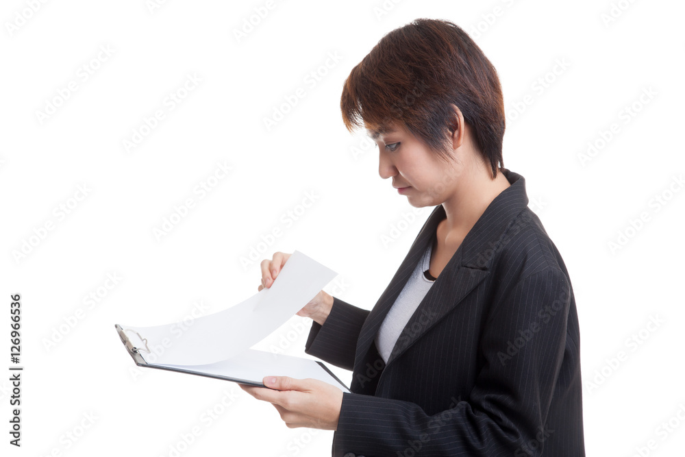 Young Asian business woman read paper on clipboard. Young Asian business woman read paper on clipboard.