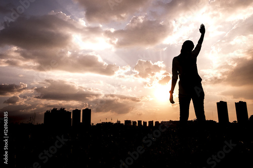 Woman in sunrise. Freedom concept.