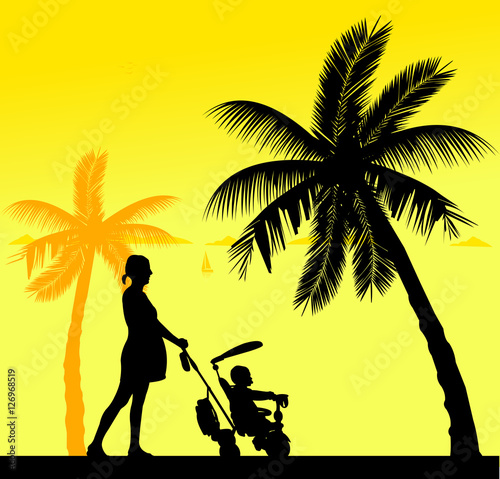 Pregnant woman walking with baby on a tricycle on the beach, one in the series of similar images silhouette
