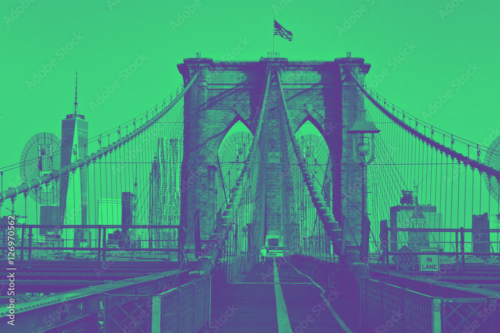 Fototapeta premium Brooklyn Bridge with flag on top. Duotone style.