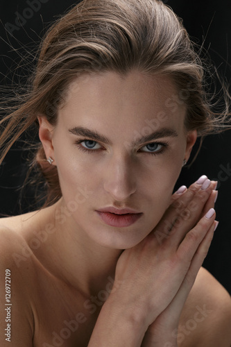 Nude woman posing in studio , in black tights