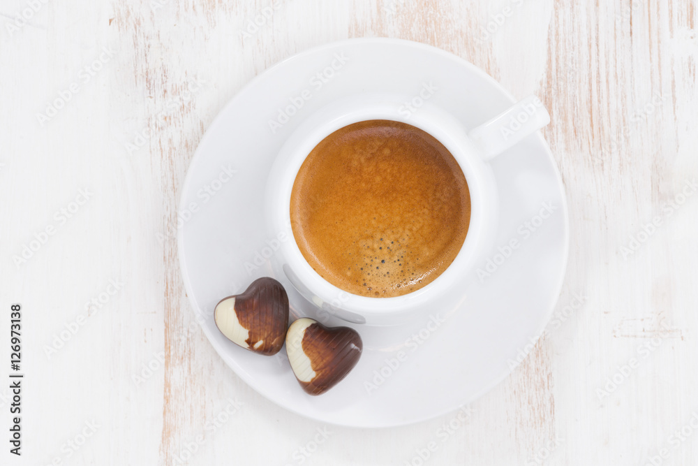 chocolate hearts and espresso on white table, top view chocolate hearts and espresso on white table, top view