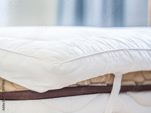 Quadro em tela Closeup of white topper on the bed in the bedroom