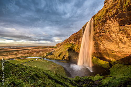 Seljalandsfoss Waterfall in Iceland at sunset.