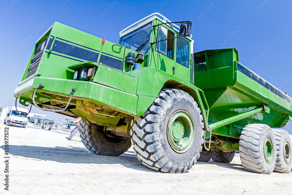 Obraz premium Close up view on dumper truck while he is passing over construct