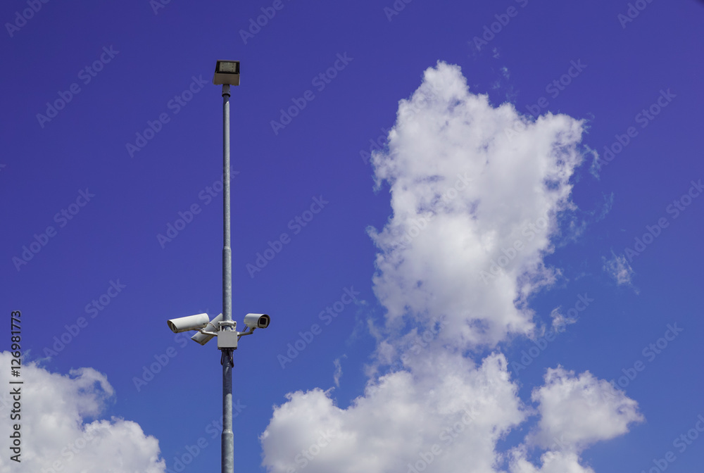 security cctv cameras on a pole with blue sky background