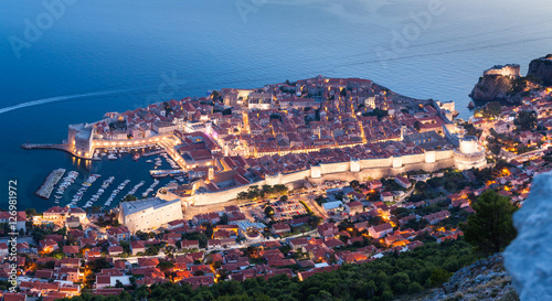Lovely panoramic view of the old walled city of Dubrovnik with bird's eye view at night. City backlit. Croatia