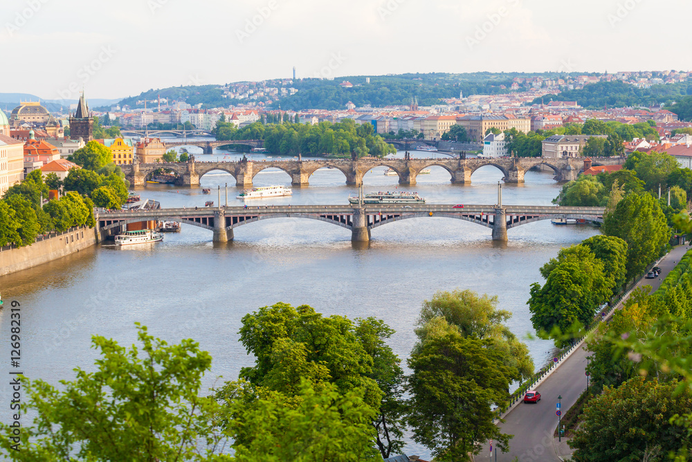Panorama of the old part of Prague from the Letna park. Beautiful view on the bridges over the river Vltava at sunset. Old Town architecture, Czech Republic.