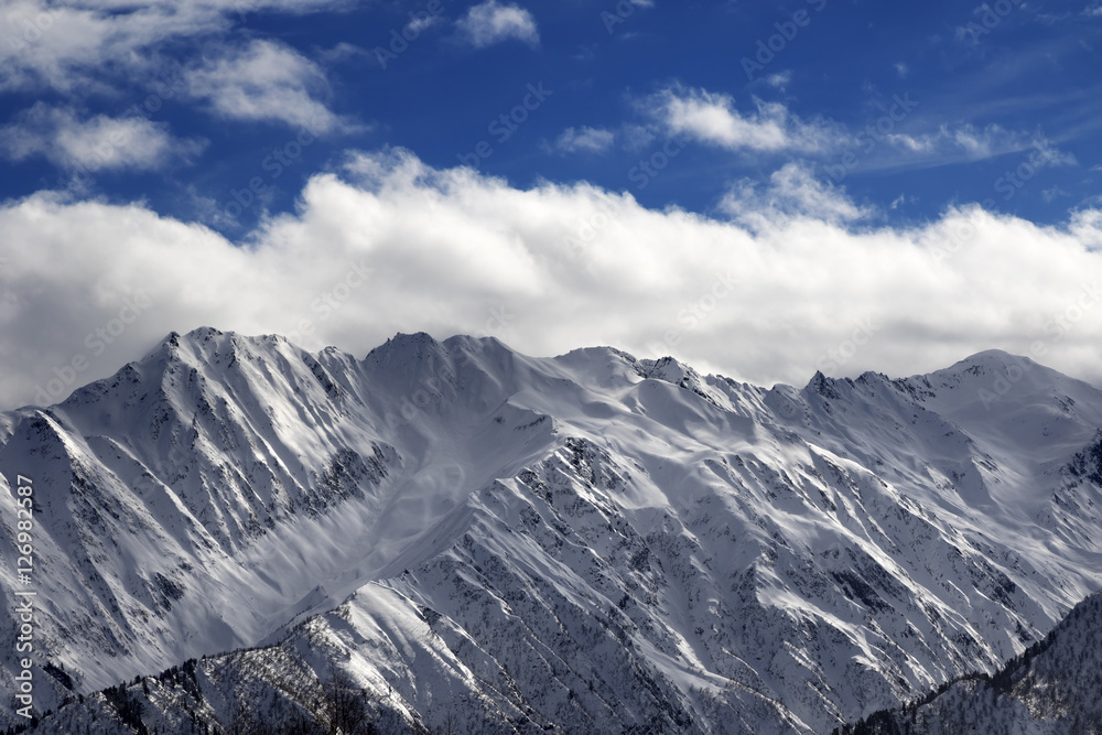 Snow winter mountains and cloud sky in sun evening Snow winter mountains and cloud sky in sun evening
