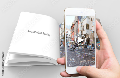 Augmented reality marketing concept. Hand holding smart phone use AR application to play video book for customer. 3d rendering photo