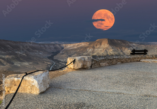 Rising of supermoon above mountains in desert of the the Negev, Israel, November 14, 2016