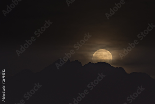 Canvas Print Rising of supermoon above mountains in the Negev, Israel, November 14, 2016