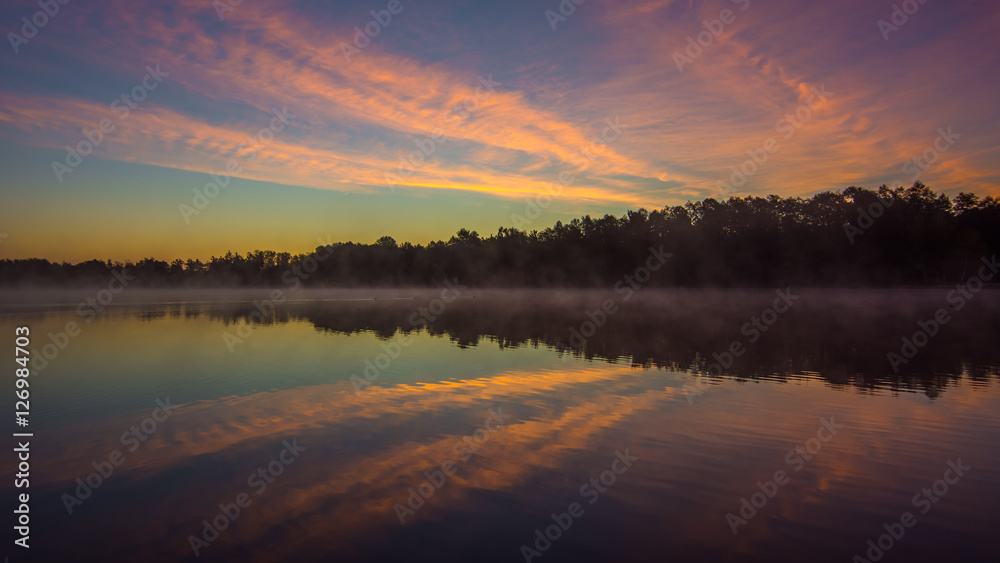 Abstract sunrise over water reflection