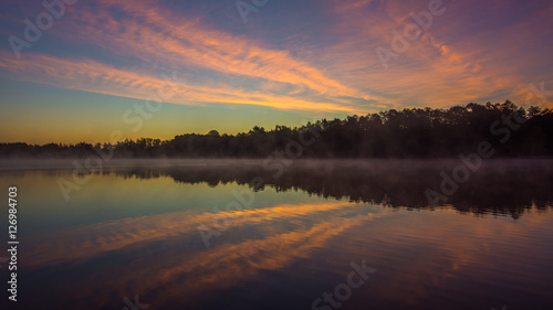 Abstract sunrise over water reflection
