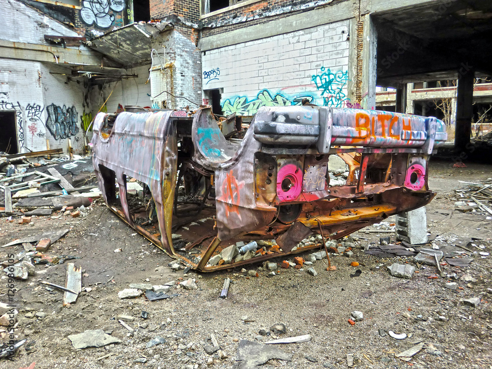 destroyed rusty van body overturned in urban ghetto