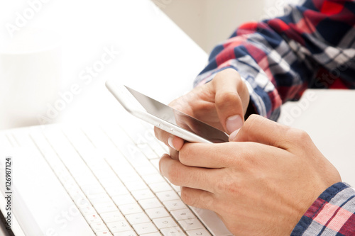 hands with mobile phone and computer