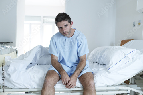 Fotografie desperate man at hospital bed alone sad and devastated suffering depression _