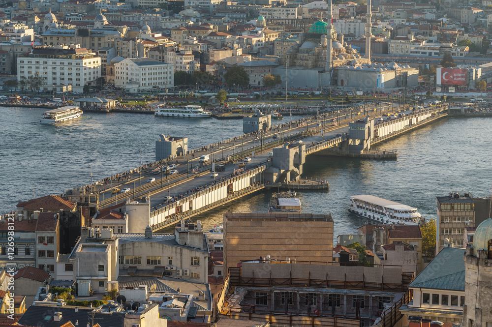 Naklejka premium View of the famous Galata Bridge and the historical center of Istanbul at sunset, Turkey 