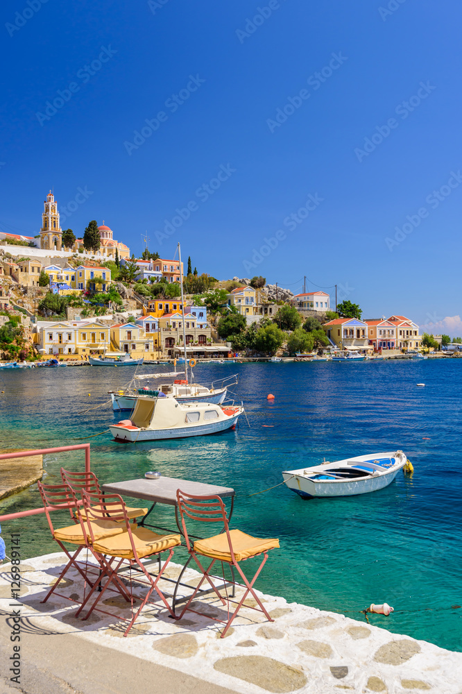 Scenic waterfront on the Greek island of Symi, Dodecanese, Greece. - obrazy, fototapety, plakaty 