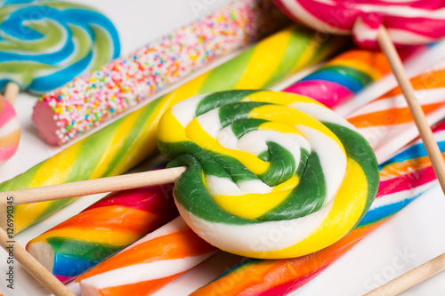Multicolored sweet candy canes and twirls on wooden sticks