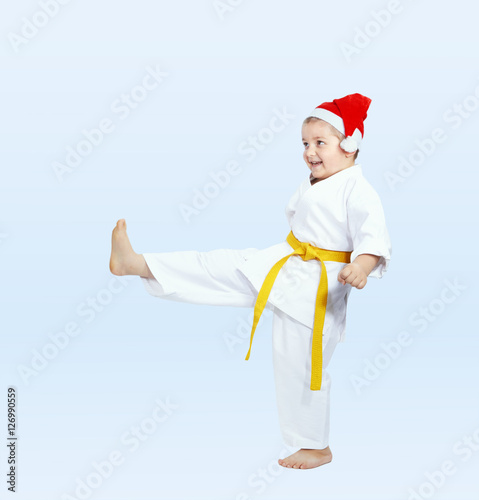 In cap of Santa Claus sportsman beats kicking