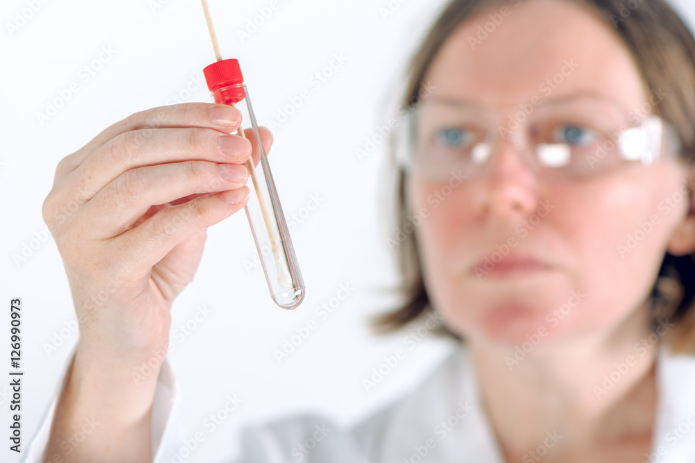 Laboratory test tube with cotton swab in scientist's hand Laboratory test tube with cotton swab in scientist's hand