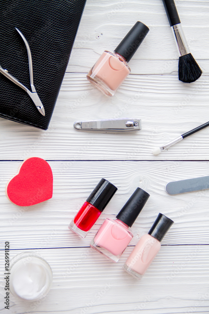 manicure set and nail polish on wooden background manicure set and nail polish on wooden background