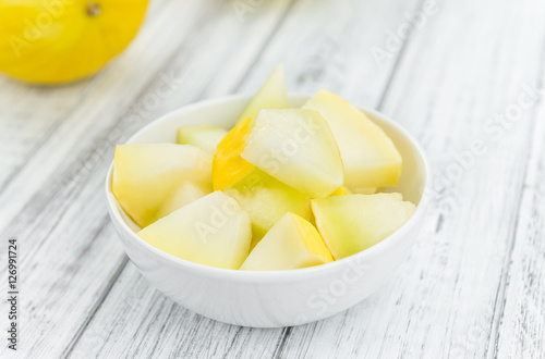 Tableau sur toile Portion of Yellow Honeydew Melon on wooden background (selective