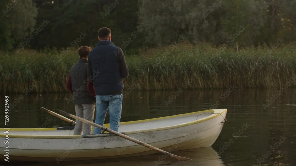 Father and Son are Standing in the Boat and Fishing. Shot on RED Cinema Camera in 4K (UHD) Father and Son are Standing in the Boat and Fishing. Shot on RED Cinema Camera in 4K (UHD)
