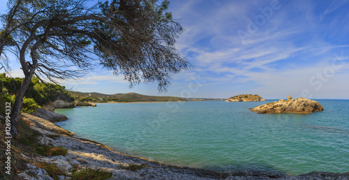 Summertime relax.The most beautiful coasts of Italy: bay of Vieste.-(Apulia, Gargano) -In the foreground the Gattarella or Portonuovo Islet and in the background the town of Vieste. photo