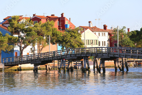 Long wooden bridge near the island of Mazzorbo in northen italy photo