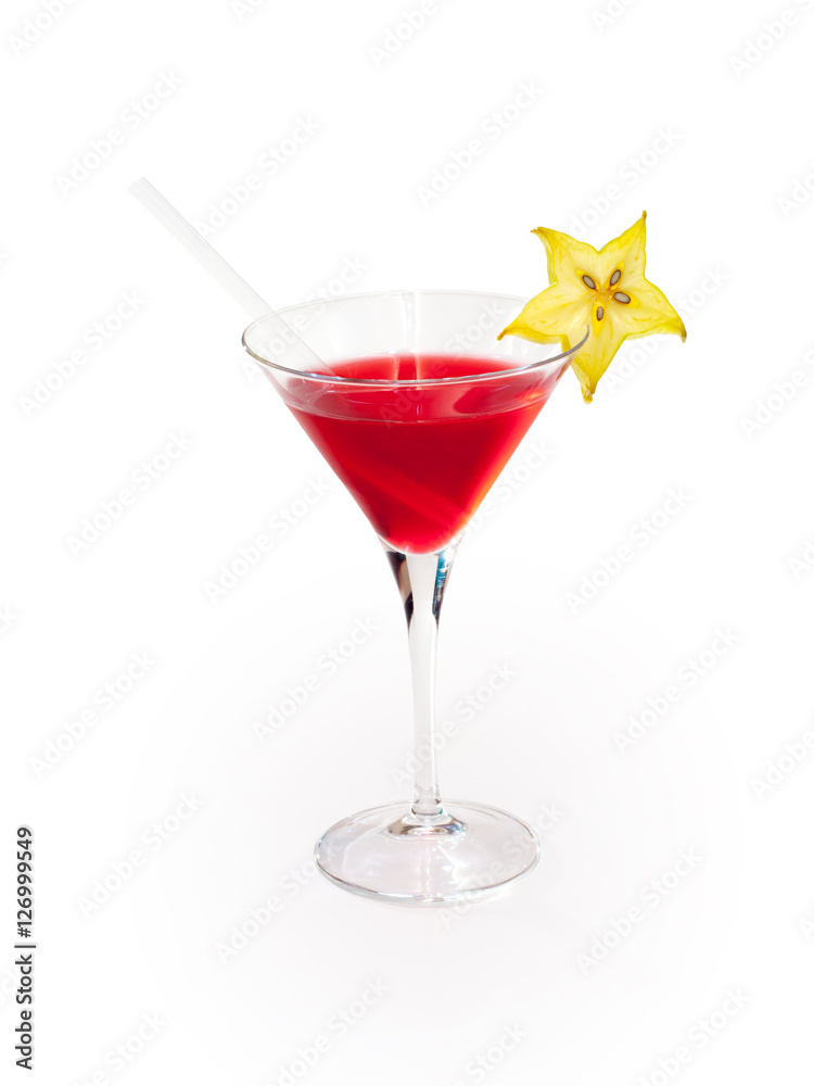 Glass of red alcoholic drink with carambola on white background