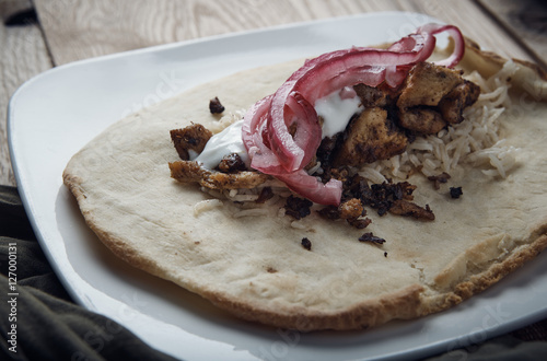 halal chicken rice pickled onions on pitas photo