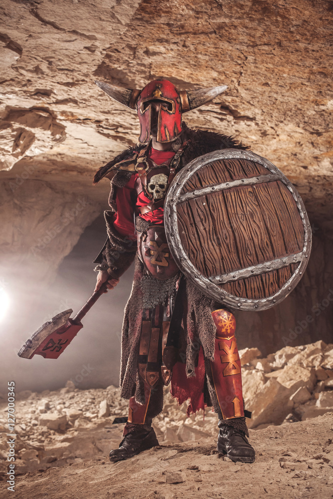 Naklejka premium Attack of powerful knight in heavy armor on the dungeon backgrou