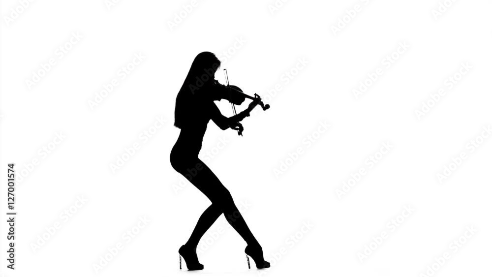 Girl violinist playing the fiddle. Silhouette Girl violinist playing the fiddle. Silhouette