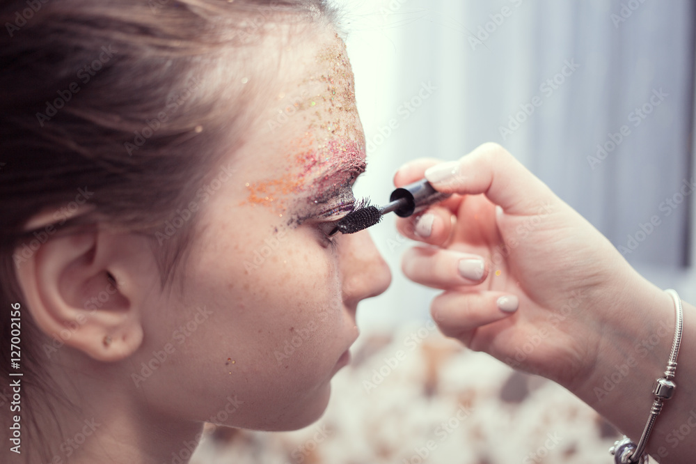 woman making curl black eyelashes in salon