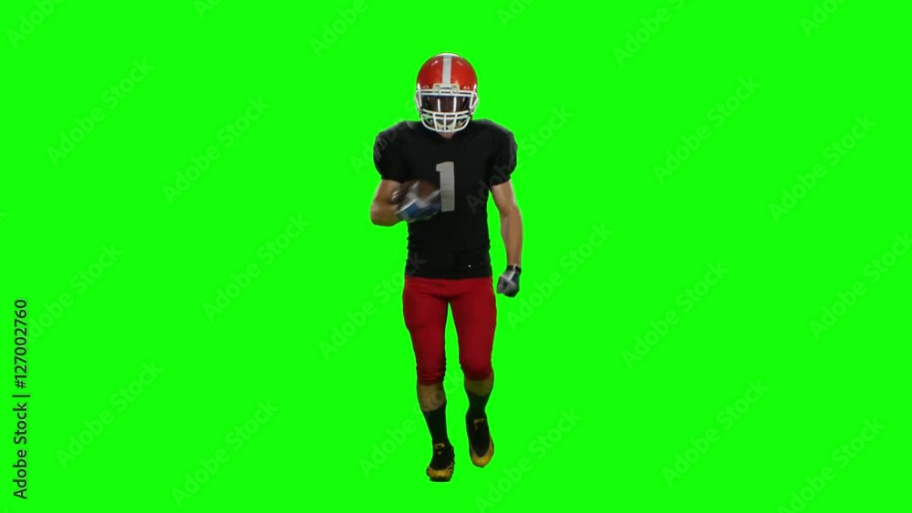 Player is running in a red helmet with the ball in his hands. Front view. Green screen Player is running in a red helmet with the ball in his hands. Front view. Green screen