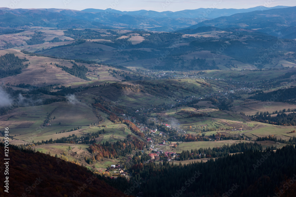 Fog above the carpathian mountain valley in autumn