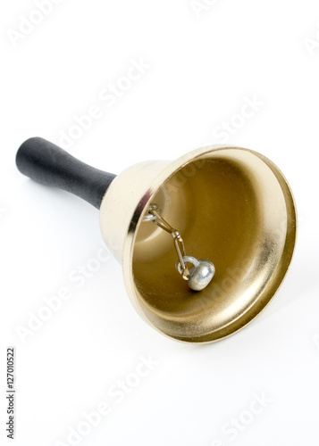 Old gold vintage school bell,hand bell made of brass with wooden handle isolated on a white background.Retro hotel bell on a white background. Concept hotel,travel, room. Service call. Christmas decor