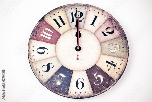 Twelve o'Clock on New Year's Eve. Face of an antique/vintage clock; indicating midnight. Christmas clock - 12 o' clock – midnight. Old-fashioned clock isolated on white background.