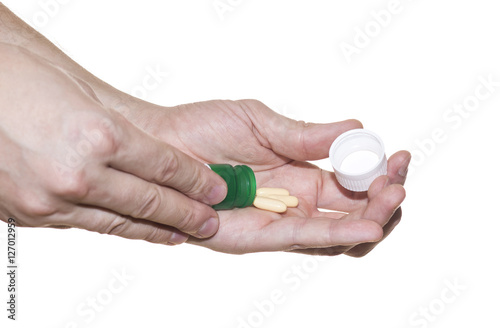 Patient gets pills from bottle isolated on white