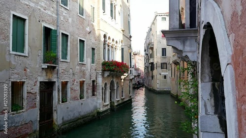 Beautiful narrow venice canal and neighborhood buildings in the water photo