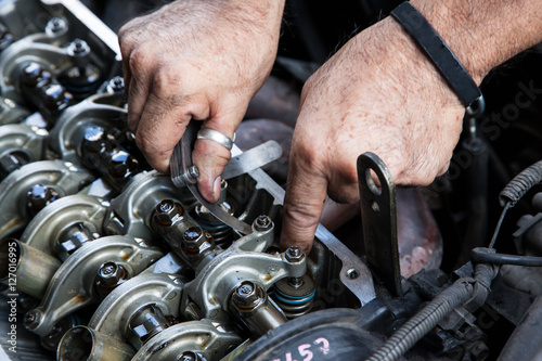 Technician service tuning engine's valve