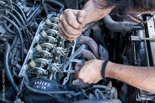 Technician service tuning engine's valve