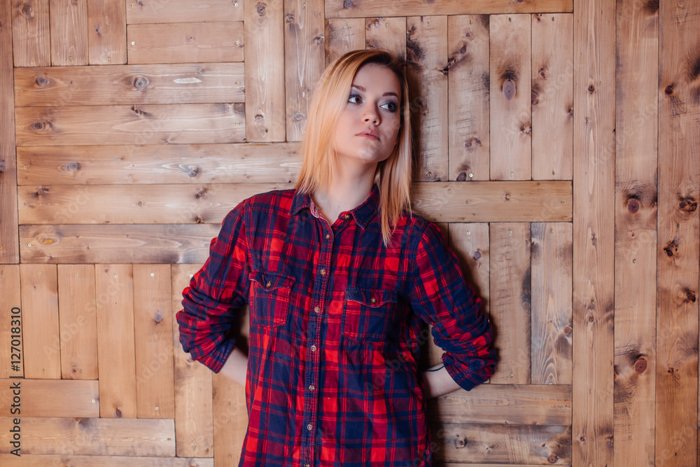 Pretty hipster girl near the wooden wall Pretty hipster girl near the wooden wall