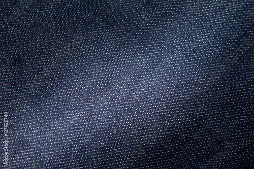 Jeans with dark blue shade. jeans background. Detail of denim je