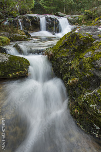 waterfall in the middle of mountain