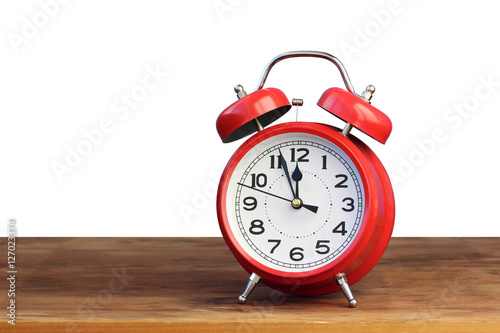 Red retro alarm clock at twelve o'clock, isolate.