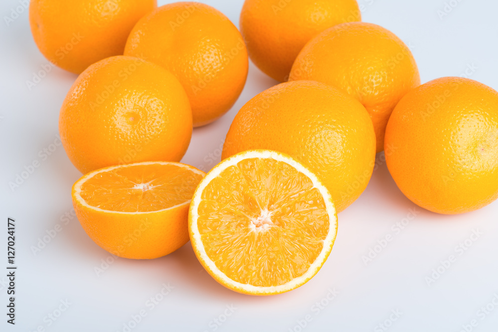 Fresh orange and cut in half on white background Fresh orange and cut in half on white background